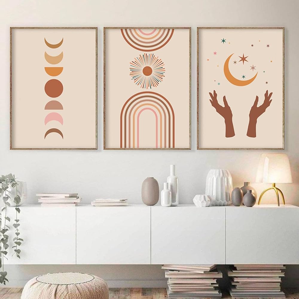 A set of three boho minimalist wall art prints featuring abstract earthy tones, curved lines, and organic shapes in beige, brown, and terracotta colors, framed and displayed on a modern wall.