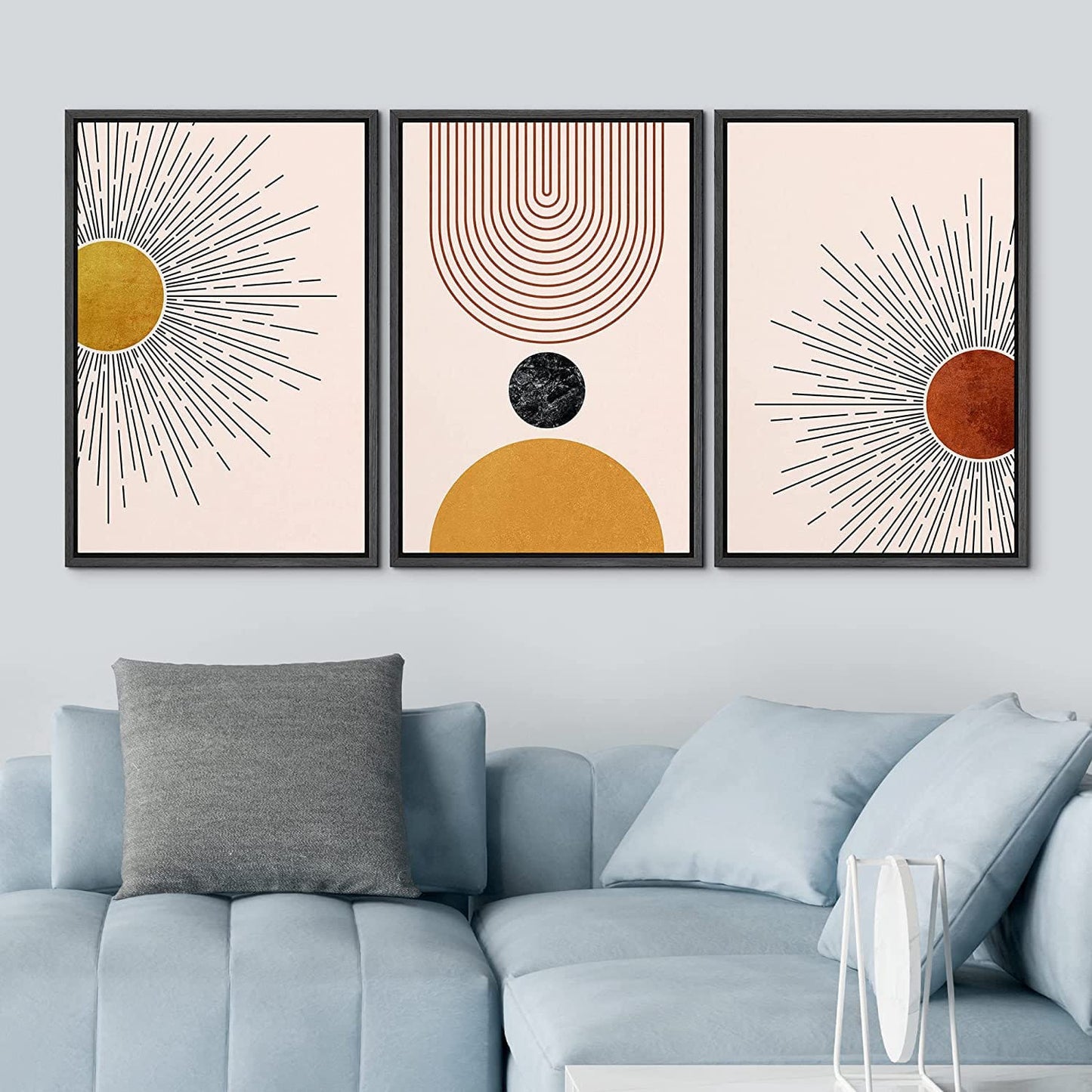 A stylish abstract wall art set depicting the sun, geometric shapes, and curved lines in warm golden, brown, and beige tones, framed and placed in a contemporary living room.
