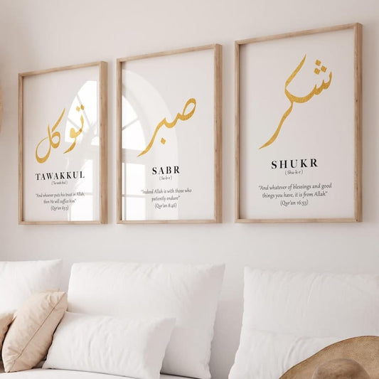 Three framed prints with Arabic calligraphy and English translations on a wall above a sofa.