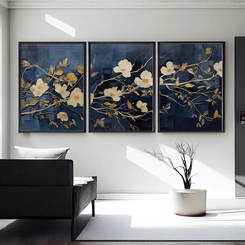 "A set of three wall frames featuring golden flowers on a deep blue background, creating a luxurious and elegant decor piece."