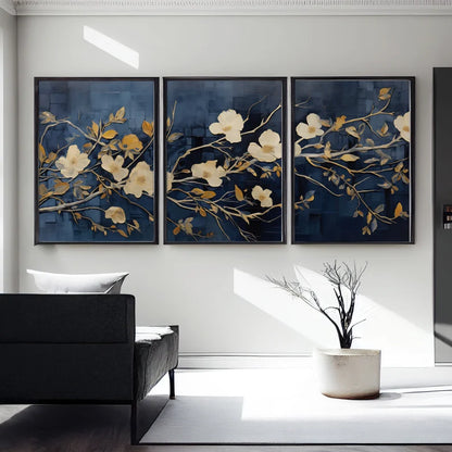 "A set of three wall frames featuring golden flowers on a deep blue background, creating a luxurious and elegant decor piece."