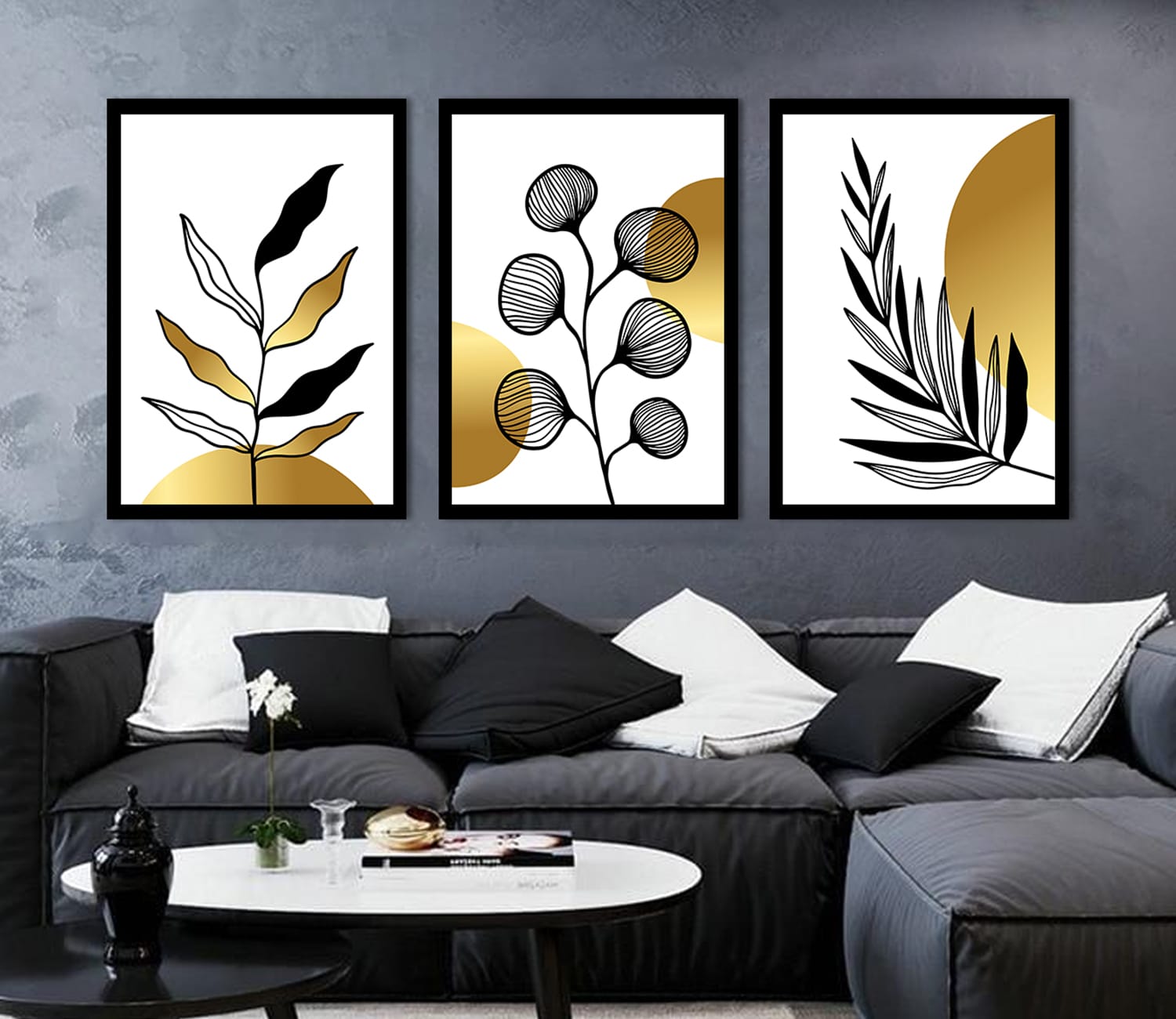 A luxurious set of three framed black and gold botanical wall art prints showcasing delicate golden leaves and floral patterns on a dark black background, adding a touch of elegance to modern home decor.