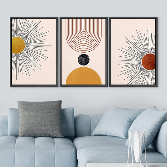 A stylish abstract wall art set depicting the sun, geometric shapes, and curved lines in warm golden, brown, and beige tones, framed and placed in a contemporary living room.