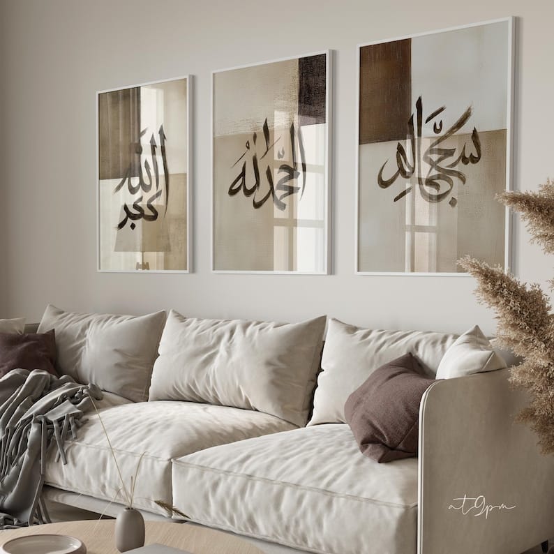 Three framed artworks with Arabic calligraphy above a beige sofa in a living room.