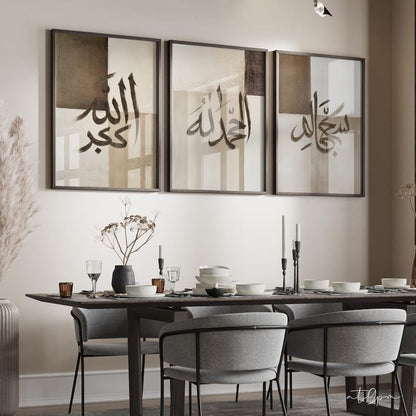 Dining room with a long table set for dinner, gray chairs, and wall art with Arabic calligraphy.