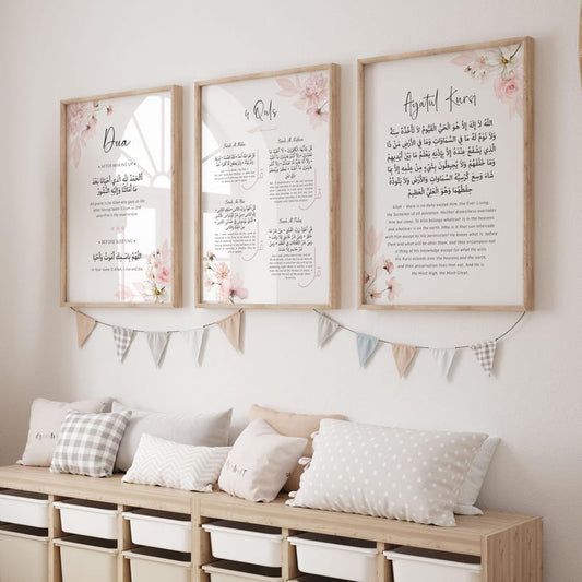 Three framed prints with floral designs and text on a wall above a wooden bench with cushions.