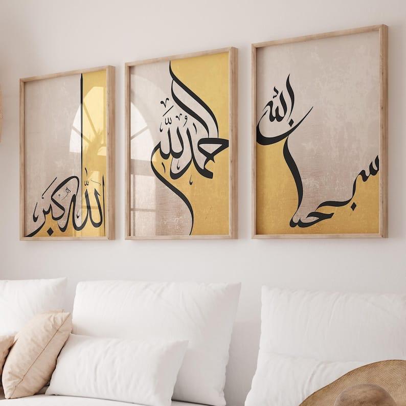 Three framed pieces of art with Arabic calligraphy on a wall above a sofa.
