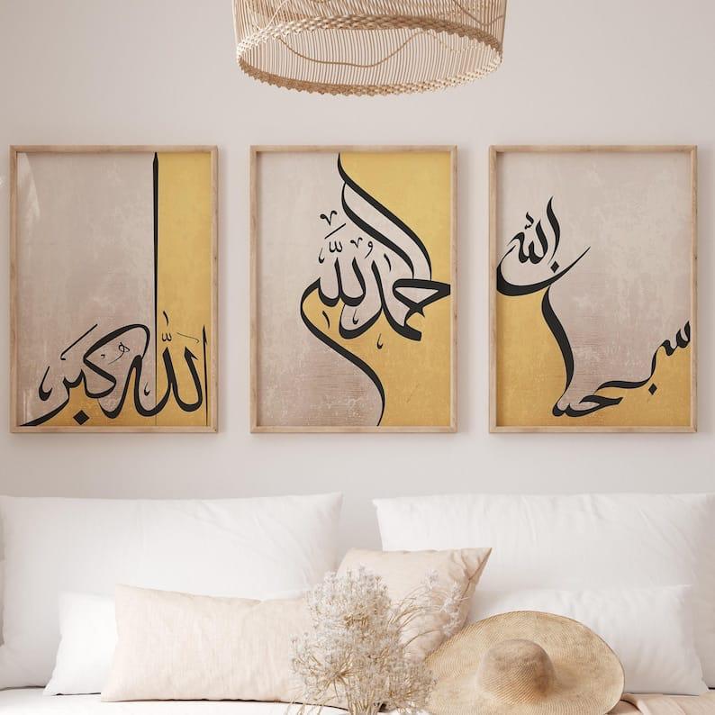 Three framed pieces of Arabic calligraphy art on a wall above a sofa.