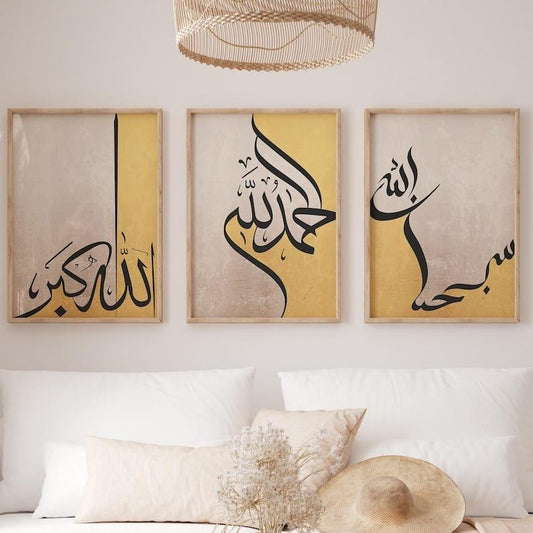 Three framed pieces of Arabic calligraphy art on a wall above a sofa.