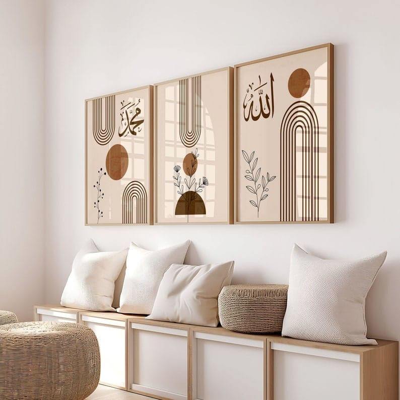 Three framed artworks on a wall above a wooden console table with cushions.