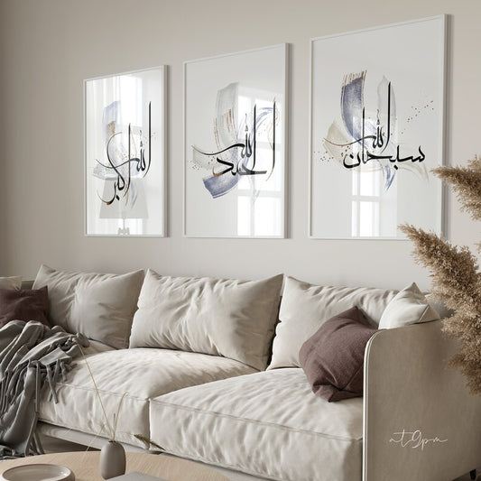 Three framed pieces of abstract art above a beige sofa with decorative pillows.
